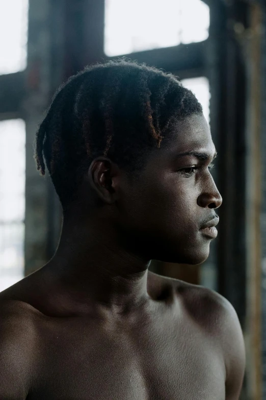 a shirtless man standing in front of a window, by Lily Delissa Joseph, young thug, medium head to shoulder shot, male teenager, backlit