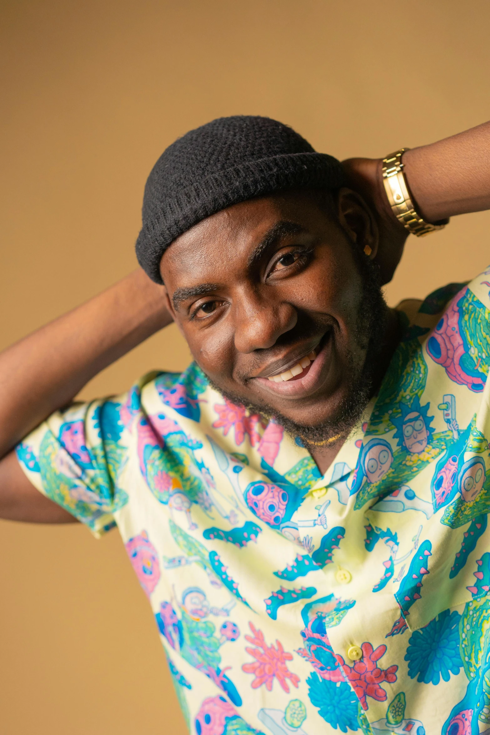 a man posing for a picture with his hands on his head, inspired by Theo Constanté, trending on pexels, colourful clothes, mkbhd, caracter with brown hat, smiling and looking directly