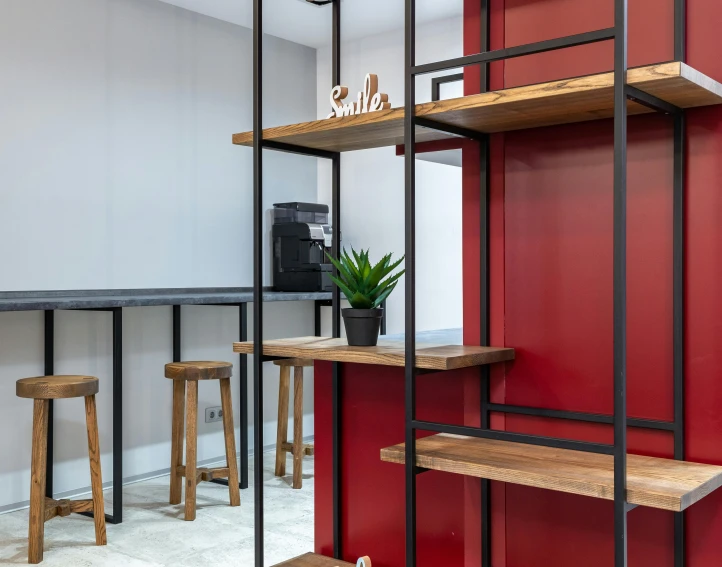 a living room filled with furniture and a red wall, unsplash, private press, black steel with red trim, simple wood shelves, android coffee shop, lockers