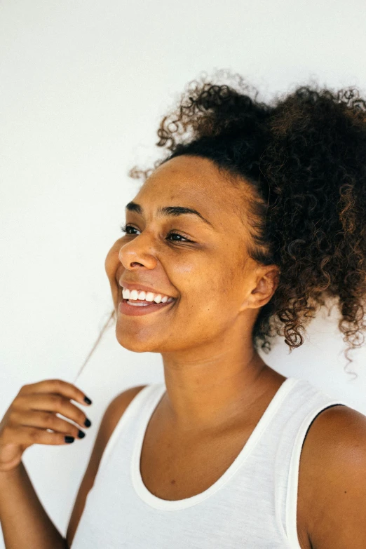 a woman brushing her teeth with a toothbrush, trending on unsplash, happening, with textured hair and skin, smiley profile, white background”, mixed race woman