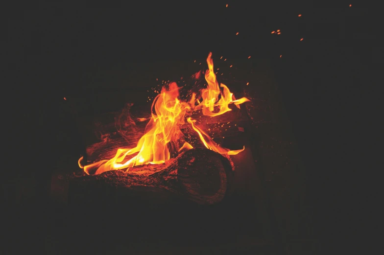 a close up of a fire in the dark, an album cover, pexels contest winner, camp, grainy, instagram post, fireflys
