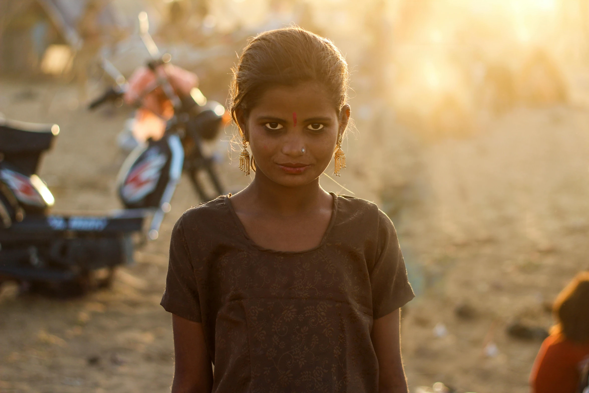 a little girl that is standing in the dirt, pexels contest winner, realism, provocative indian, sunny lighting, portrait of teenage girl, an film still