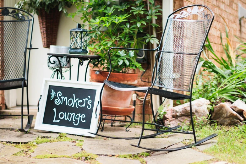 a couple of chairs and a sign that says smokers lounge, pexels, art & language, garden setting, ivy's, portrait image, chalked