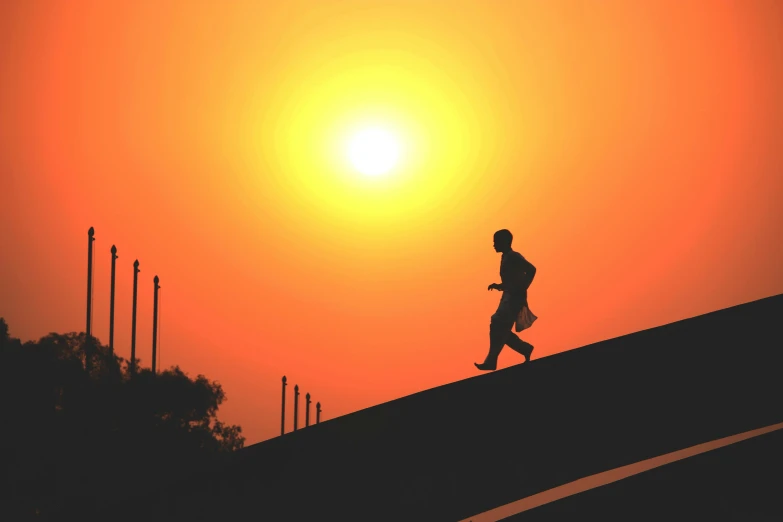 a man running up a hill at sunset, pexels contest winner, orange and black, avatar image, heat wave, soft shadow