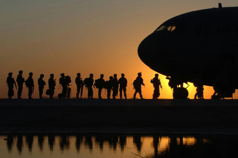 a large jetliner sitting on top of an airport tarmac, by Brad Holland, pexels contest winner, hurufiyya, soldiers charging in, saving private ryan, sun rising, avatar image