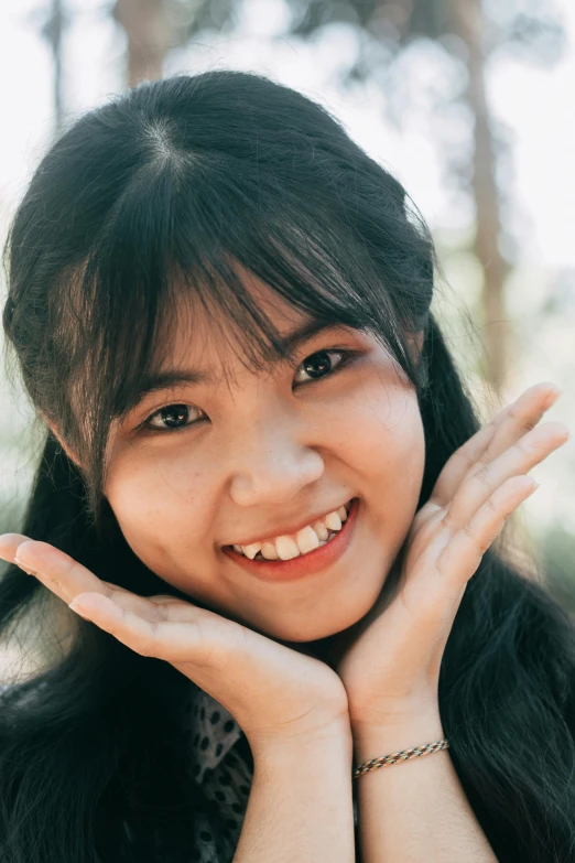 a woman with long black hair posing for a picture, inspired by Kim Jeong-hui, pexels contest winner, smiling girl, hands shielding face, portrait close - up, vietnamese woman