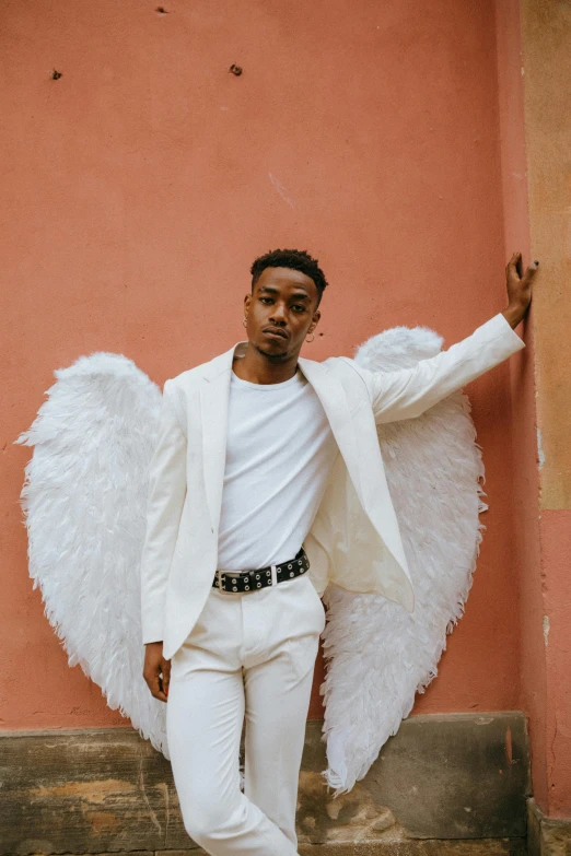 a man in a white suit and angel wings, by Cosmo Alexander, pexels contest winner, renaissance, playboi carti portrait, non binary model, cupid, full body full height