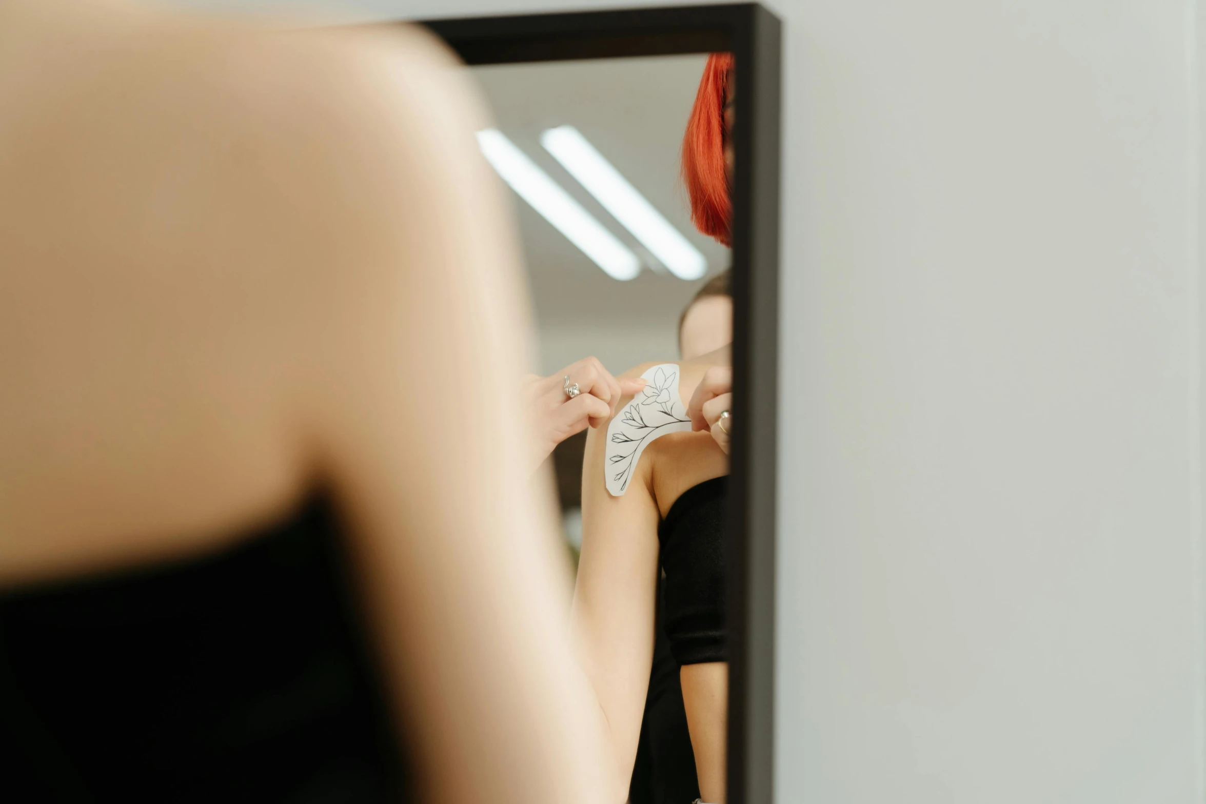 a woman brushing her teeth in front of a mirror, a photo, by Emma Andijewska, trending on pexels, art nouveau, showing her shoulder from back, reflective scales, with a white background, sydney hanson