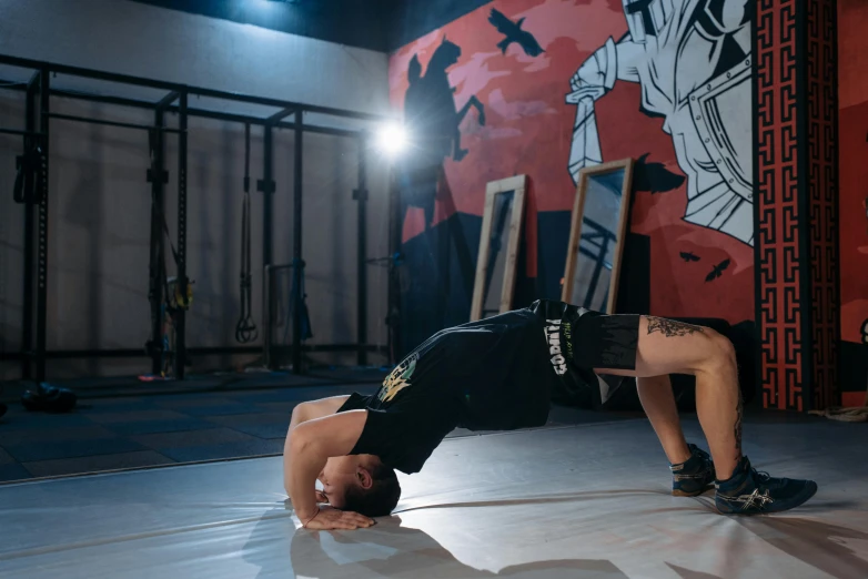 a man doing a handstand in a gym, a portrait, unsplash, graffiti, background image, ernest khalimov body, crawling on the ground, manuka