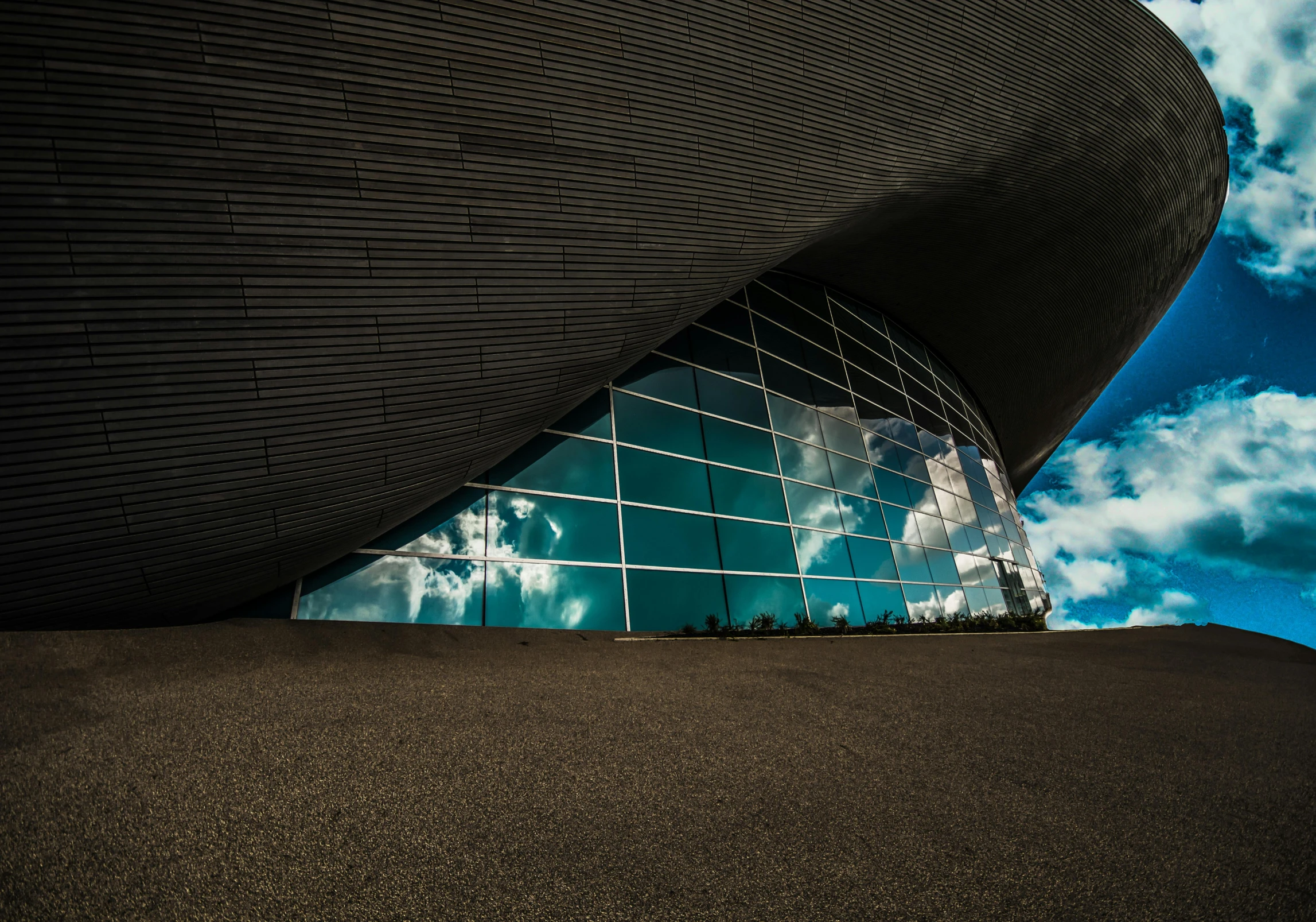 a close up of a building with a sky in the background, a picture, inspired by Zaha Hadid, unsplash contest winner, underwater view, lpoty, sweeping arches, ground level shot