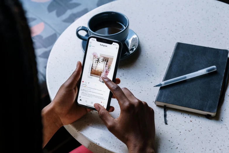 a person sitting at a table using a cell phone, a picture, trending on pexels, happening, detailed product image, instagram highlights, dwell, riyahd cassiem