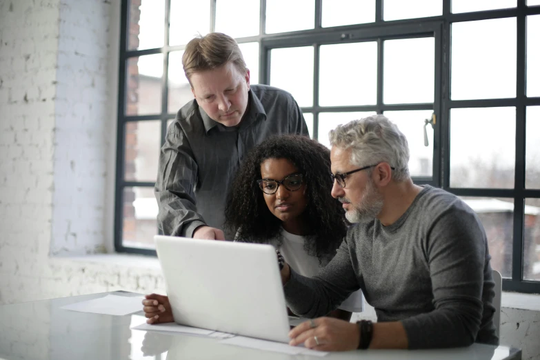 two men and a woman looking at a laptop, by Carey Morris, pexels, renaissance, grey, agile, design thinking, light on top