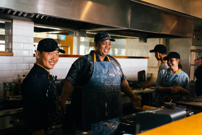 a group of men standing next to each other in a kitchen, unsplash, mcdonalds restaurant, woodfired, ngai victo and dougherty patrick, profile image