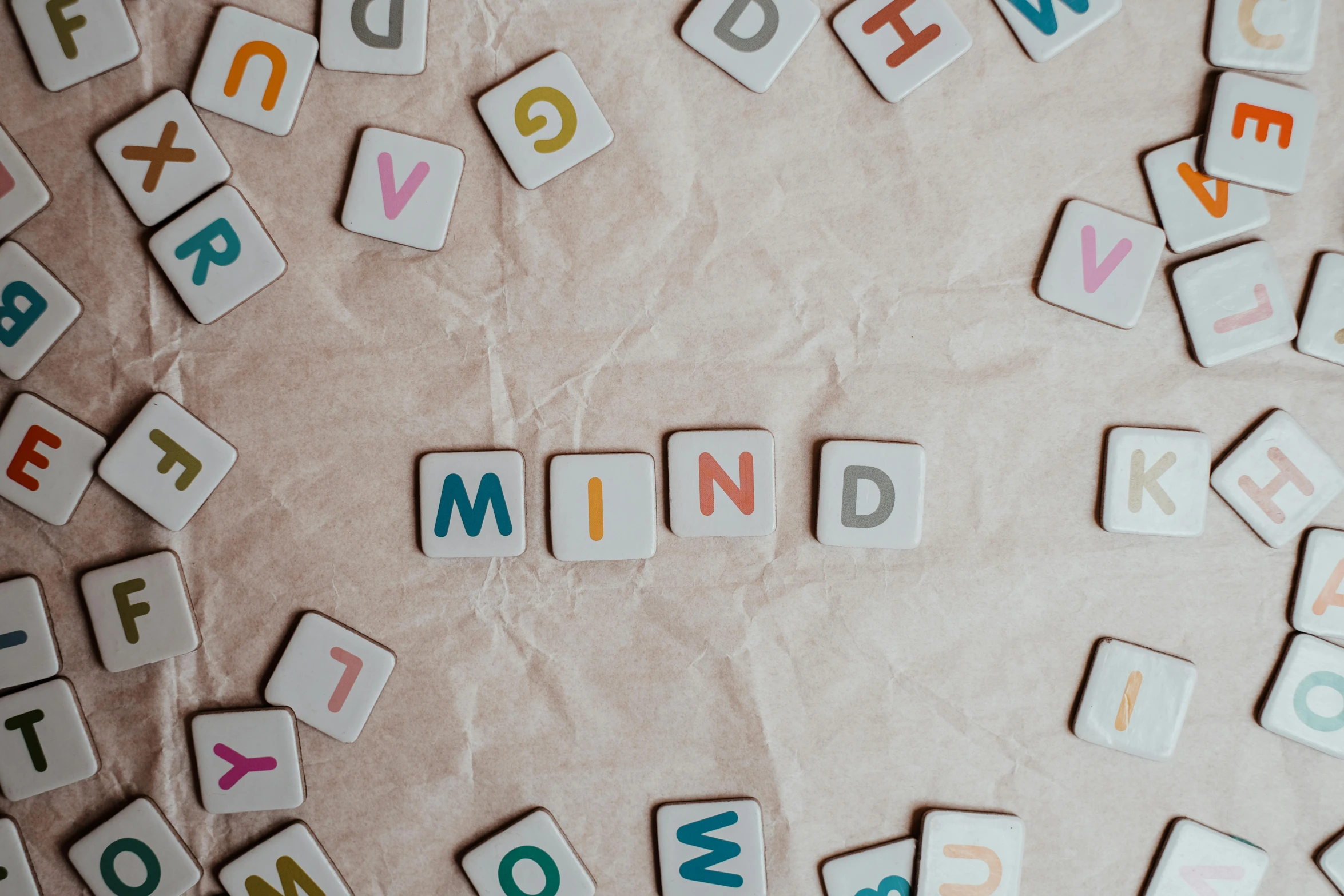 a pile of scrabbles sitting on top of a table, by Emma Andijewska, trending on pexels, letterism, mind, background image, anything that comes into my mind, seen from below