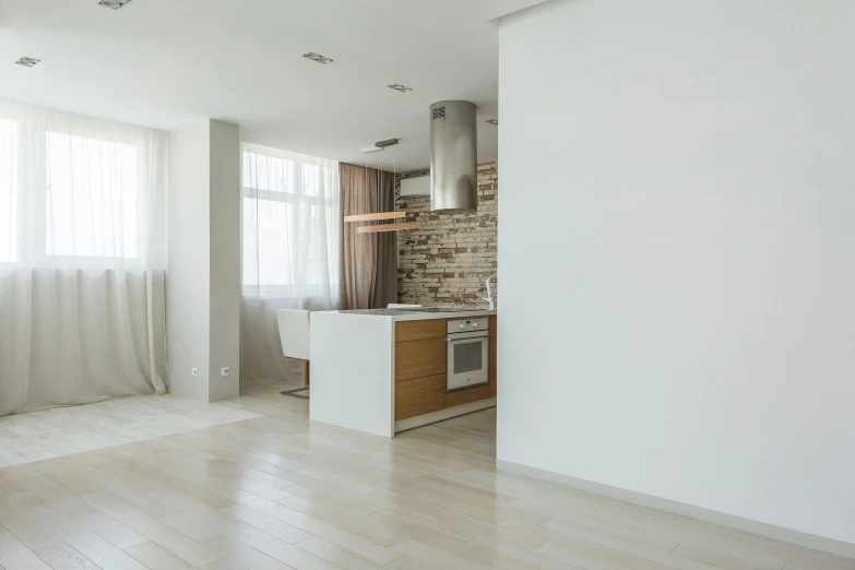 a kitchen with a stove top oven sitting on top of a hard wood floor, a 3D render, by Andries Stock, pexels contest winner, light and space, interior white wall, beige color scheme, interior of a loft, interior of a small