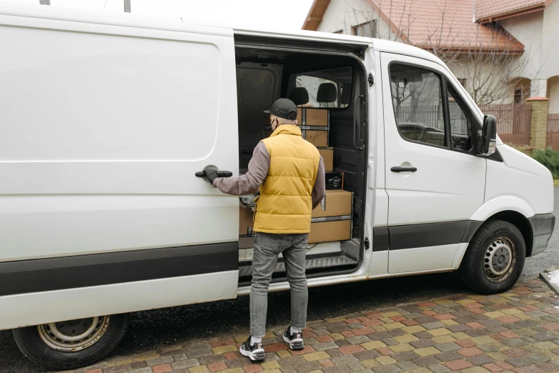 a man loading a box into the back of a van, pexels contest winner, thumbnail, full frame image, ad image, non-binary