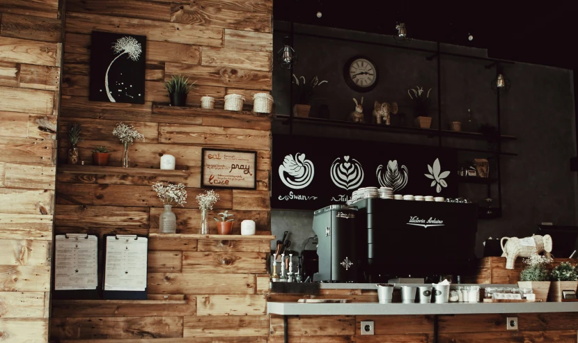 a close up of a counter in a restaurant, inspired by Elsa Bleda, trending on unsplash, coffee art, background image, wooden walls with framed art, thumbnail