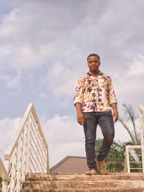 a man standing on top of a set of stairs, by Ella Guru, wearing yellow floral blouse, david uzochukwu, casual pose, ((oversaturated))