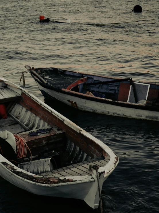 a couple of boats sitting on top of a body of water, by Elsa Bleda, pexels contest winner, cinematic detail, battered, 8k resolution octane renderer, nostalgic and melancholic 4 k