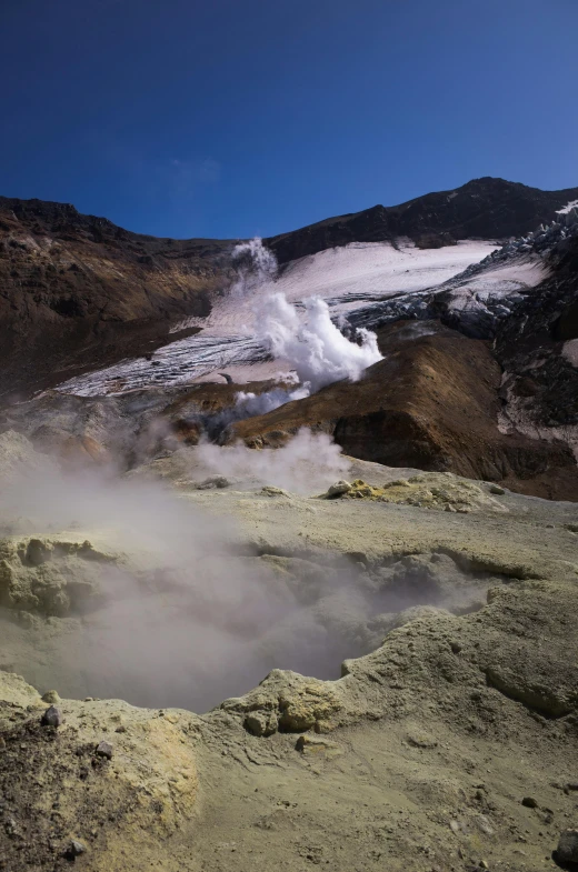 a mountain with steam coming out of it, sulfur, an eerie whirlpool, cryogenic pods, lerapi