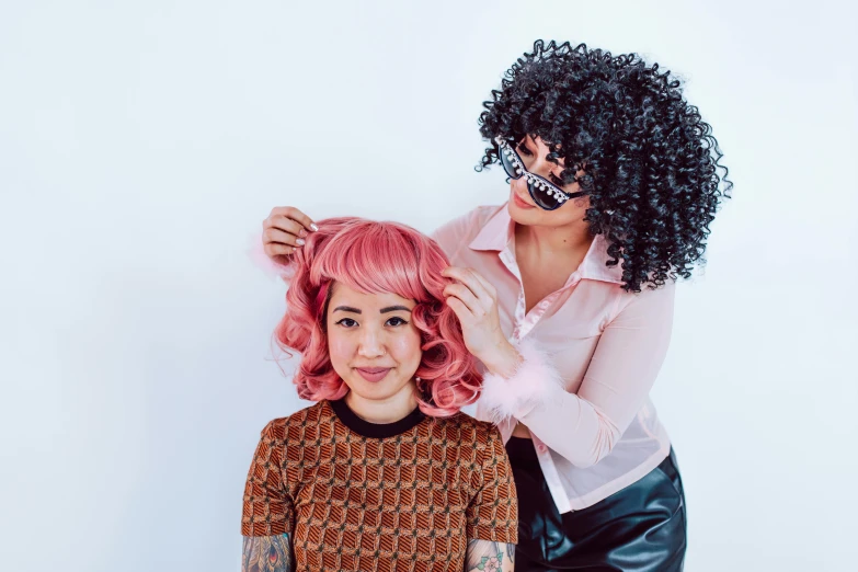 a woman cutting another woman's hair with scissors, by Julia Pishtar, trending on pexels, kitsch movement, huge curly pink hair, diverse costumes, set against a white background, black curly hair