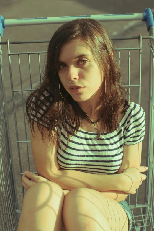 a woman is sitting in a shopping cart, an album cover, inspired by Elsa Bleda, flickr, alexandra daddario, mugshot, !female, dua lipa