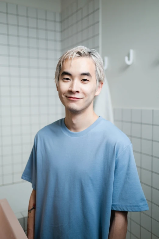 a man standing in front of a mirror in a bathroom, inspired by jeonseok lee, platinum hair, smiling slightly, plain background, 2 5 year old