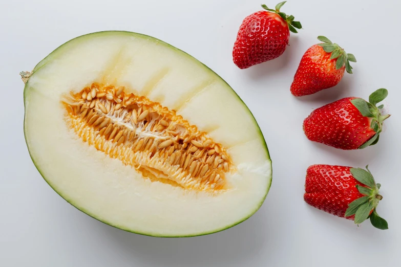 a melon and some strawberries on a white surface, a picture, by Matthias Stom, shutterstock contest winner, hurufiyya, pretty oval face, assemble, detailed product image, highly upvoted