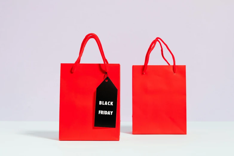 two red shopping bags with a black friday tag, by Julia Pishtar, hurufiyya, all black matte product, amanda clarke, bright:, miniature product photo