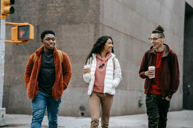 a group of people walking down a city street, trending on pexels, brown skinned, at college, promotional image, background image