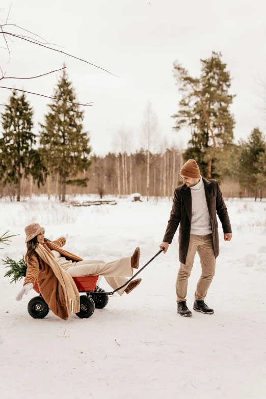 a man pulling a wagon with a christmas tree in it, by Julia Pishtar, pexels contest winner, romanticism, happy couple, arctic, brown, fatherly