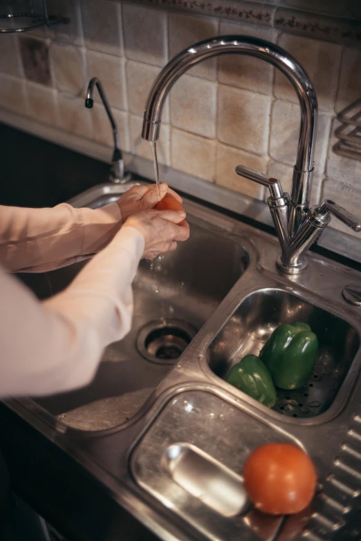 a woman washing vegetables in a kitchen sink, pexels contest winner, renaissance, single pair of hands, polished, struggling, video