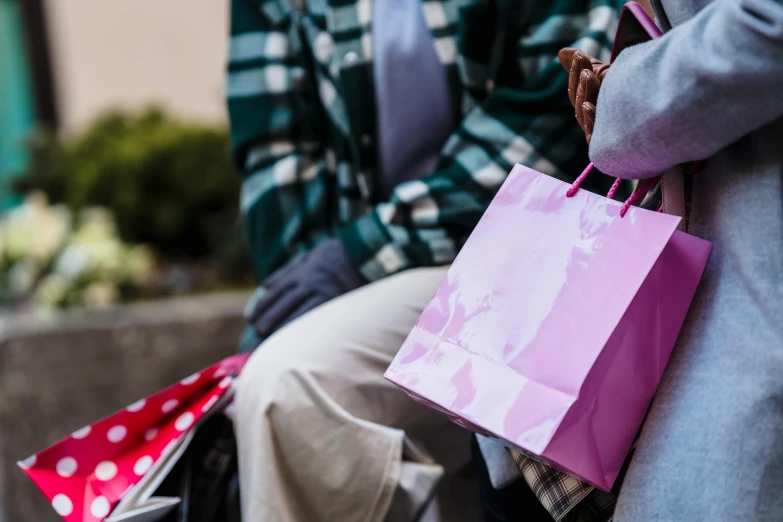 two people sitting on a bench with shopping bags, pexels contest winner, pink, uncropped, family friendly, half image