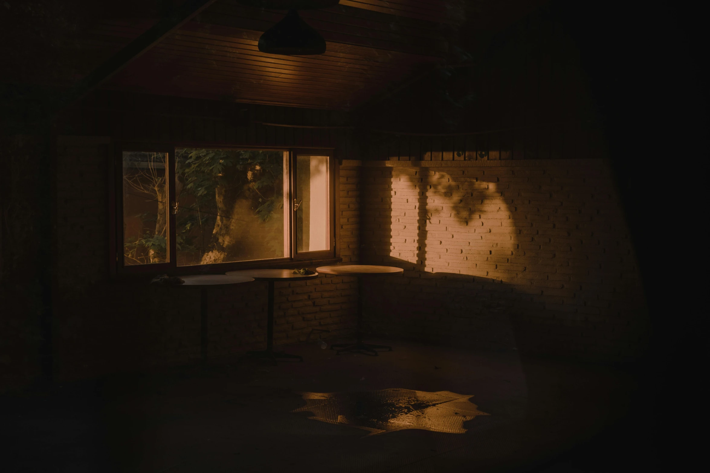 the sun shines through a window in a dark room, a picture, inspired by Elsa Bleda, unsplash contest winner, australian tonalism, light casting onto the ground, haunted house interior, light inside the hut, dark kitchen of an art student