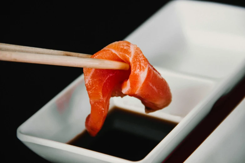 a close up of a plate of food with chopsticks, inspired by Kanō Shōsenin, unsplash, sōsaku hanga, salmon, pointè pose, 4 k smooth, the red ninja