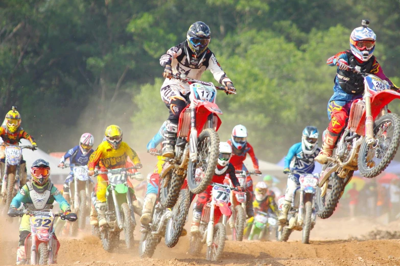 a group of people riding dirt bikes on a dirt track, avatar image, festivals, profile image, close - up photo