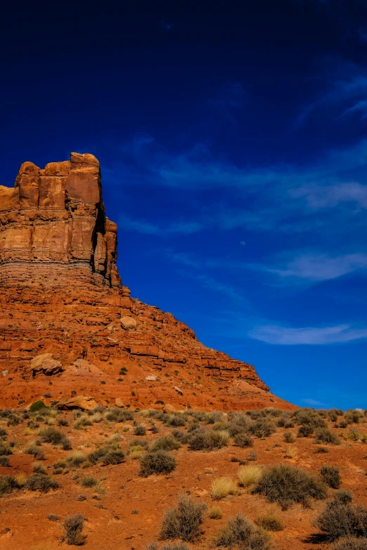 a large rock formation in the middle of a desert, towering over your view, slide show, stacked image