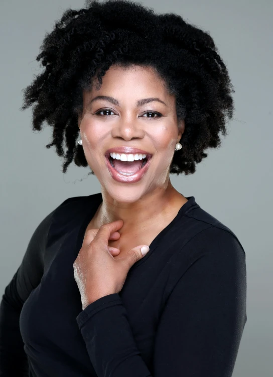 a woman in a black shirt posing for a picture, natural hair, head bent back in laughter, actor, profile image