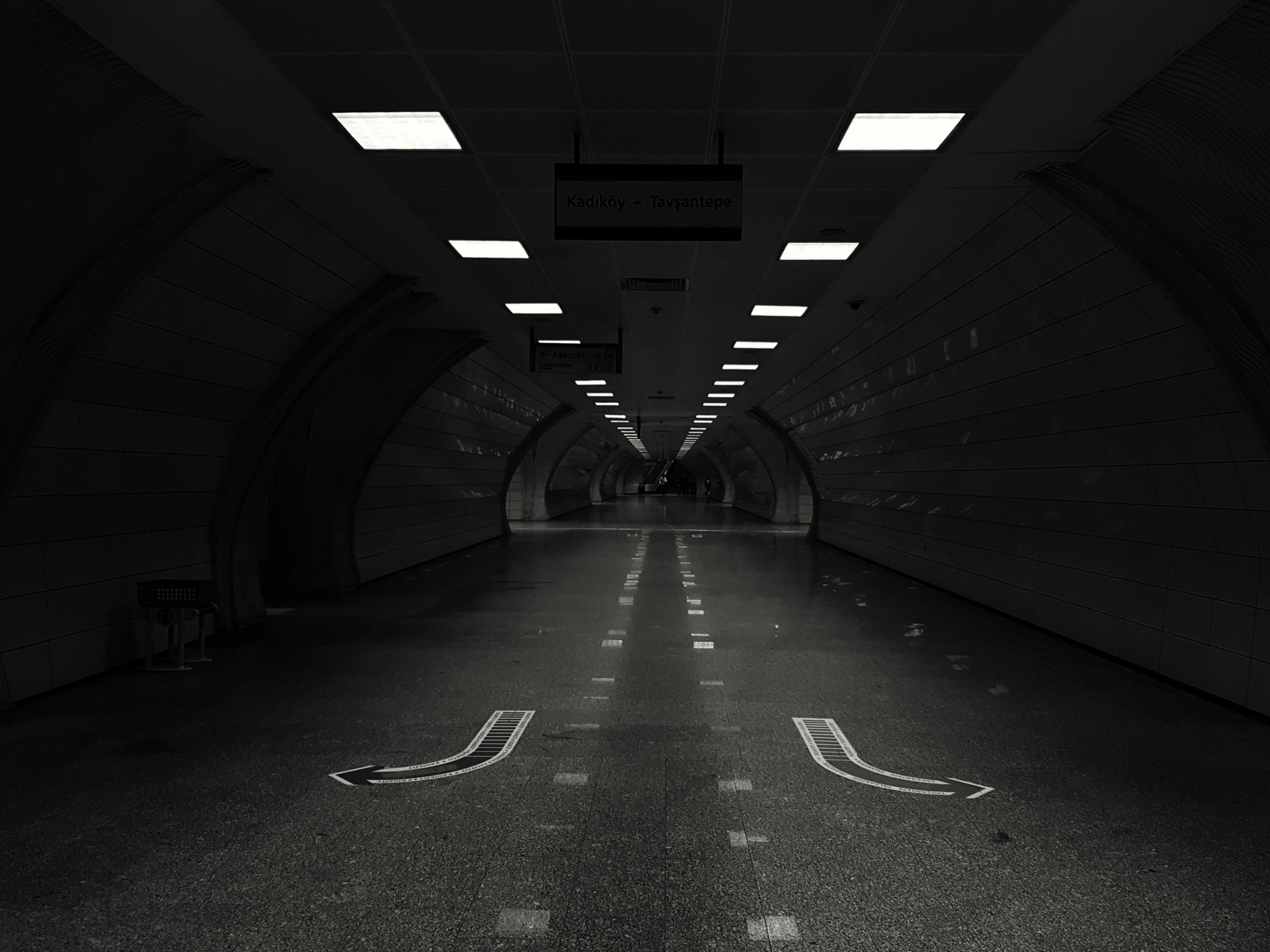 a black and white photo of an empty tunnel, an album cover, made in unreal engine 4, hyperrealistic symmetrical 8k, empty streetscapes, volumetric search lights