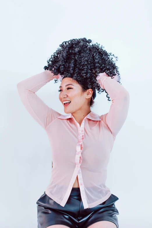 a woman in a pink shirt and black leather shorts, by Natasha Tan, featured on instagram, curls on top of his head, expressing joy, promo image, mai anh tran