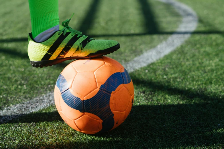 a person standing on top of a soccer ball, trending on dribble, zoomed in, profile image, green and orange theme, laces