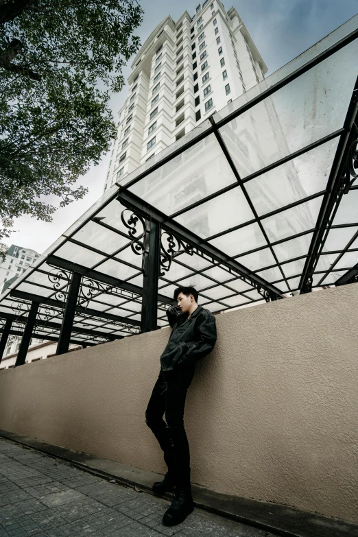 a man leaning against a wall in front of a building, an album cover, inspired by Zhang Han, unsplash contest winner, city rooftop, background image, isolate translucent, fullbody photo