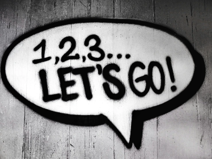 a black and white photo of a sign that says let's go, flickr, graffiti, threes, 12, speech bubbles, countdown