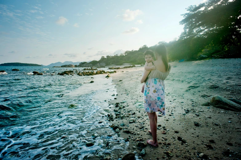 a woman standing on a beach next to the ocean, malaysian, precious moments, slide show, seraphine