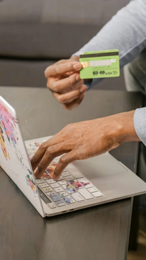 a man holding a credit card and using a laptop, by Daarken, colorized photograph, fan favorite, ap, square