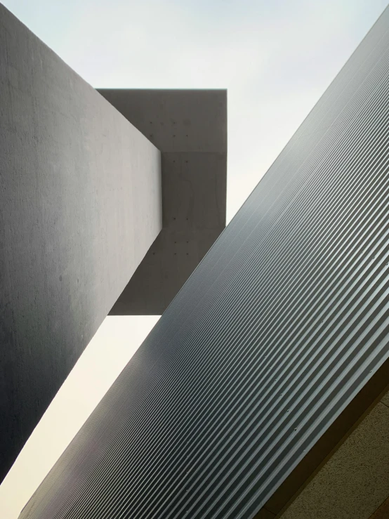 a couple of buildings that are next to each other, an abstract sculpture, inspired by David Chipperfield, unsplash contest winner, detail shot, bill lowe gallery, heavy lines, light and dark