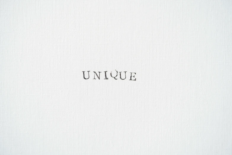 a white shirt with the word unique written on it, an album cover, by Shigeru Aoki, international typographic style, fine texture detail, white canvas background, ffffound, handcrafted paper background