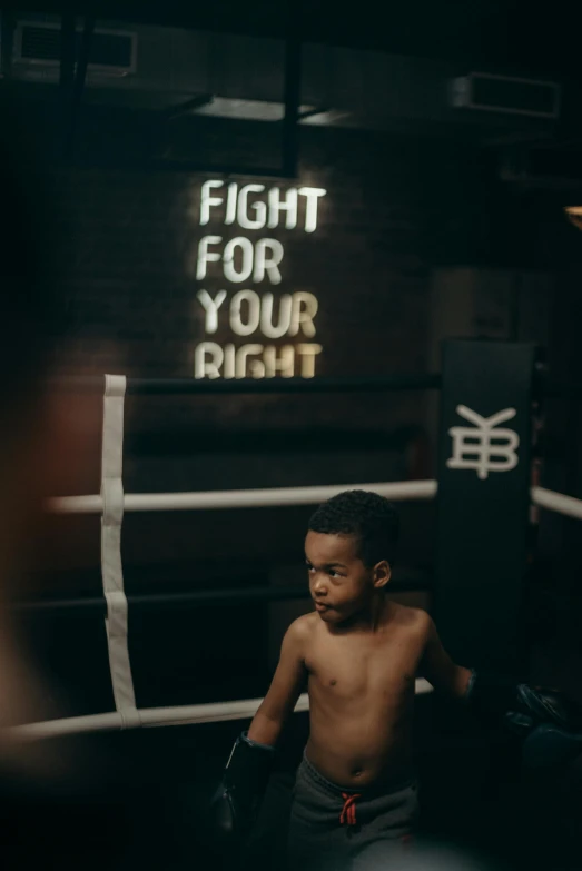 a young boy standing in a boxing ring, by Niko Henrichon, pexels contest winner, bright signage, teddy fresh, gif, full leight