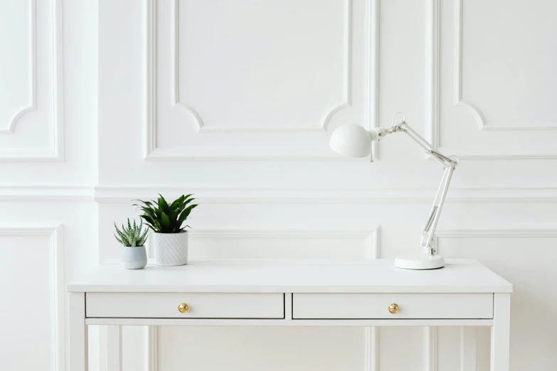 a white desk with a potted plant on top of it, pexels contest winner, smooth panelling, white and silver, background image, table light