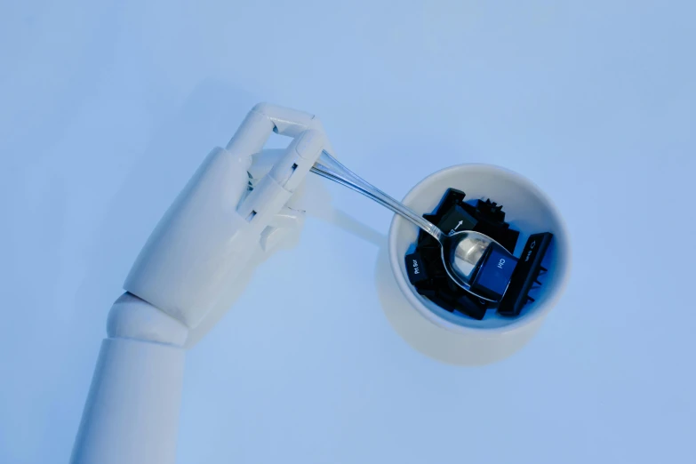 a close up of a person's hand holding a toothbrush, inspired by Marcel Duchamp, unsplash, neo-dada, with a robotic arm, blue, high - angle view, white